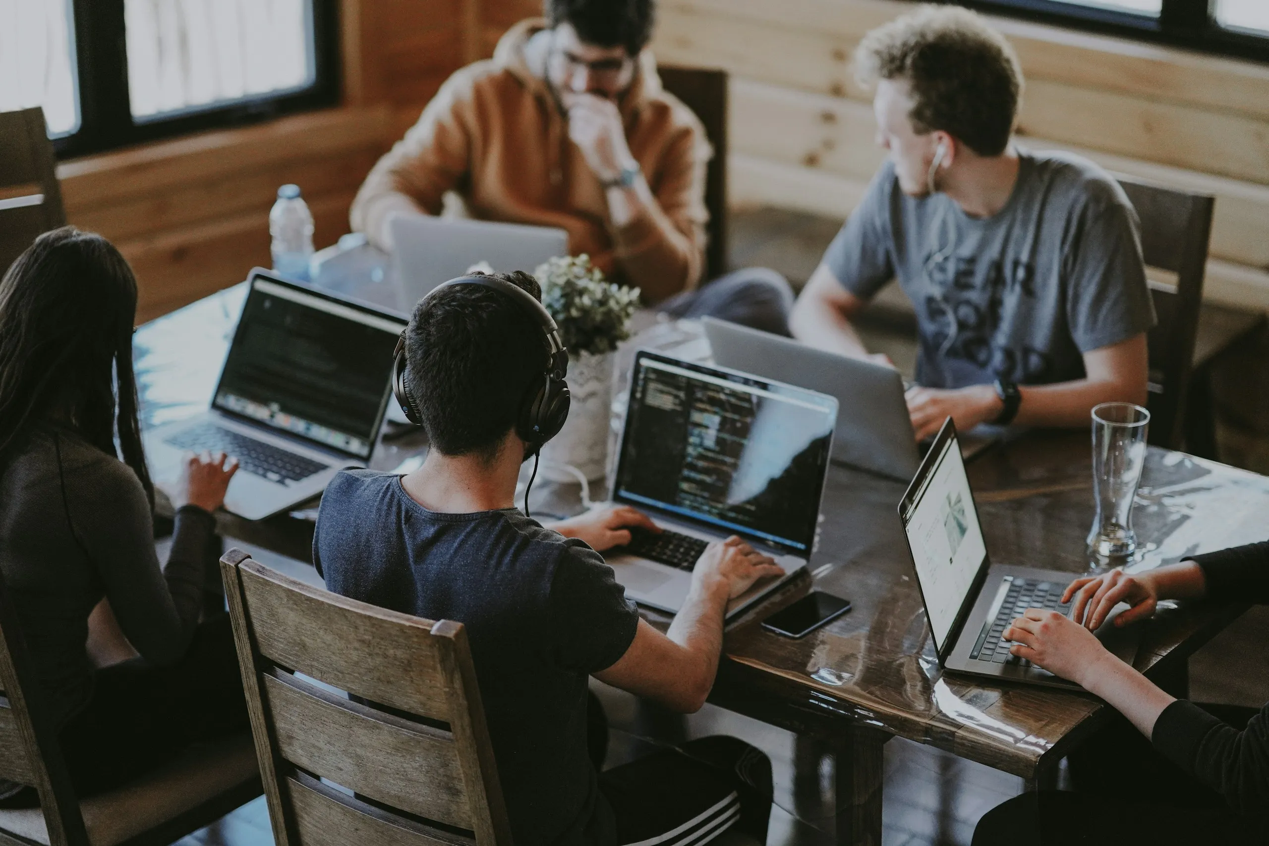 Colleagues collaborating around a table in a bright open-plan office